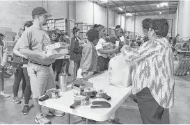  ?? Rebecca Elliott / Houston Chronicle ?? Volunteers with BE A Resource for CPS Kids sort and prepare holiday gifts for children under CPS care Saturday in a Heights neighborho­od warehouse.