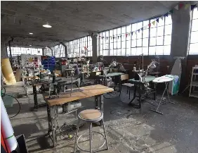  ?? ?? Industrial sewing machines lined up in the textiles area on the third floor. The equipment was purchased from a garment factory that closed down in Scarboroug­h.