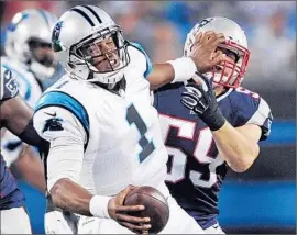  ?? Mike McCarn
Associated Press ?? CAROLINA’S CAM NEWTON is sacked by New England’s James Morris during the first half of a preseason game in North Carolina. The Patriots won, 17-16.