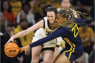  ?? CHARLIE NEIBERGALL — THE ASSOCIATED PRESS ?? West Virginia’s Lauren Fields, right, tries to steal the ball from Iowa’s Caitlin Clark in Monday’s game.