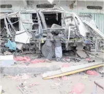  ?? — Reuters ?? Boys inspect the wreckage of a bus at the scene of Thursday’s air strike in Saada province, Yemen.