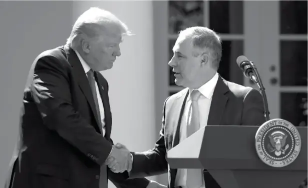  ?? AP ?? WASHINGTON. In this June 1, file photo, President Donald Trump shakes hands with EPA Administra­tor Scott Pruitt after speaking about the U.S. role in the Paris climate change accord in the Rose Garden of the White House in Washington.