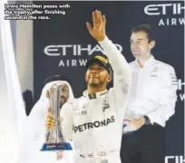  ??  ?? Lewis Hamilton poses with the trophy after finishing second in the race.