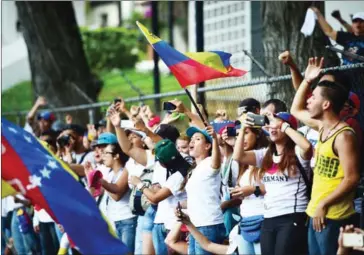  ?? RONALDO SCHEMIDT/AFP ?? Venezuelan opposition activists march to the Catholic Church’s episcopal seat in a quiet show of condemnati­on of the government of President Nicolás Maduro, in Caracas, on Saturday.