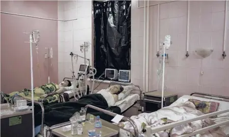  ?? FELIPE DANA/AP ?? Civilians who were injured during a Russian artillery attack are treated in a hospital Saturday in Kharkiv.