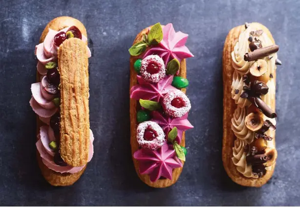  ??  ?? ÉCLAIR FUTURE Above from left: sour cherry, raspberry cheesecake and basil, and tiramisù éclairs by Nicolas Poelaert of Choux Pâtisserie in Newcastle, NSW.