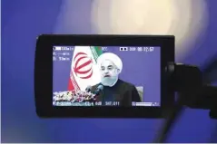  ?? — AFP ?? TEHRAN: A screen shows newly re-elected Iranian President Hassan Rouhani delivering a televised speech in the capital Tehran yesterday.