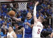  ?? JOHN RAOUX — THE ASSOCIATED PRESS ?? Magic guard Cole Anthony makes a shot as he gets past Cavaliers guard Sam Merrill during the second half of Thursday’s game in Orlando, Fla.