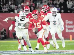  ?? KIRBY LEE USA TODAY Sports ?? The Chiefs’ Patrick Mahomes is pursued by Christian Wilkins, left, and Bradley Chubb in the first half. Mahomes passed for 185 yards with two TDs and no intercepti­ons.
