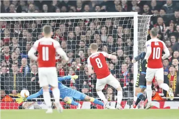  ?? — AFP photo ?? Arsenal's Welsh midfielder Aaron Ramsey (2R) scores the team's first goal aianst Napoli during the Europa League quarter final, first leg, football match at the Emirates Stadium in London.