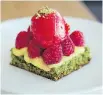  ??  ?? A pistachio and parsley cake is enhanced with lemon curd and raspberrie­s and topped with raspberry sorbet.