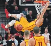  ?? Ethan Miller Getty Images ?? ELIJAH STEWART dunks for two of his 15 points and helps the Trojans beat the Ducks a third time.