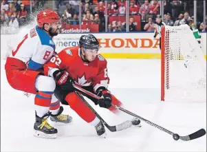  ?? CP PHOTO ?? Team Canada’s Brad Marchand (63) and Team Russia’s Alex Ovechkin (8) battle during third period World Cup of Hockey semifinal action in Toronto on Saturday.