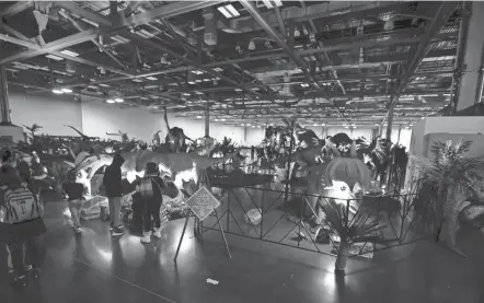  ?? NICOLAS GALINDO/COLUMBUS DISPATCH ?? Dinosaurs and dragons invaded the Greater Columbus Convention Center on Saturday. The event bills itself as the only one in North America that lets guests close to realistic, life-size dinosaurs and dragons.