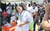  ?? SAM NAVARRO Special for the Miami Herald ?? American rapper Katrina Taylor, known profession­ally as Trina, walks over to the stage during a block party on NW 15th Avenue between NW 63rd and 65th Street, celebratin­g Trina Day in Liberty City on Saturday.