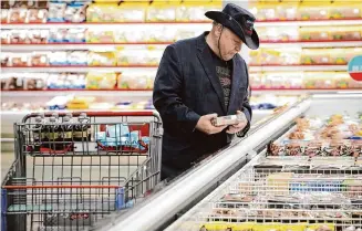  ?? Jon Shapley/Staff photograph­er ?? Rick Hawley buys boudin egg at an H-E-B in Katy. Americans pay 21% more for groceries than they did in 2021, according to the Brookings Institute.