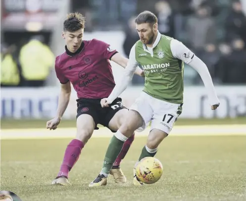  ??  ?? 0 Hibs’ Martin Boyle, right, with Celtic’s Kieran Tierney on Sunday, was surprised to get a new deal from Neil Lennon, far left.