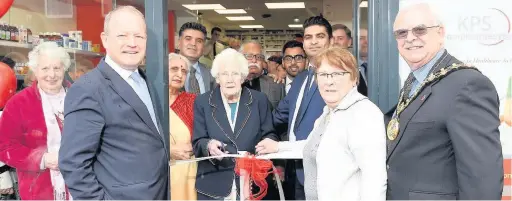  ??  ?? ●●Gladys Liddell, 100, cuts the ribbon to open the revamped Oldham Road Pharmacy in Rochdale. Watched by MP Simon Danczuk, Coun Lynne Brosnan and the Mayor Coun Ray Dutton