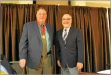  ??  ?? Tom Savage receives the Chet Henry Fire Service Advocacy Award from Gene Bidoli.