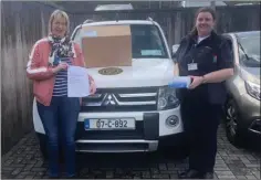  ??  ?? Cllr Maura Bell presents masks to Sinead Furlong of Civil Defence.