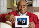  ?? HYOSUB SHIN / HSHIN@AJC.COM ?? Dr. Louis Sullivan holds his photograph with George H.W. Bush and the late Barbara Bush.