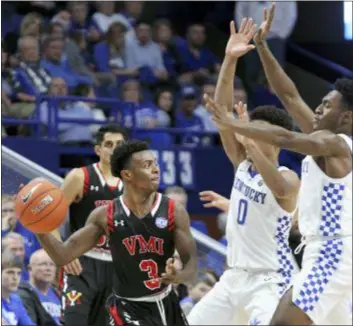  ?? JAMES CRISP — THE ASSOCIATED PRESS ?? Virginia Military’s Bubba Parham passes around Kentucky defenders Quade Green and Immanuel Quickley, right, during the second half Sunday’s game in Lexington, Ky., Sunday. Kentucky won 92-82.