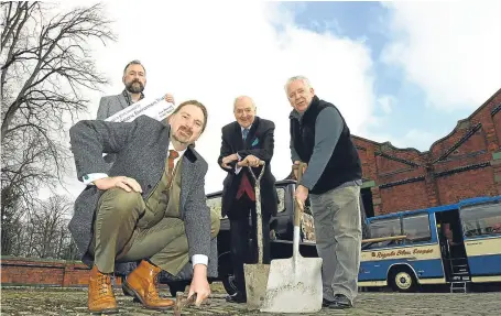  ?? Picture: Dougie Nicolson. ?? Chris Law MP lends a hand at the launch of the first phase of works yesterday with, from left, Dundee Historic Environmen­t Trust director Adam Swan, Dundee Museum of Transport trustee Norman Robertson and museum chairman Jim McDonnell.