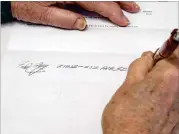  ?? GREG GILBERT / SEATTLE TIMES ?? Fred Foy demonstrat­es his steady handwritin­g. His right hand once shook so badly he couldn’t hold a cup of coffffee. He’s one of four people undergoing a clinical trial for brain implants.