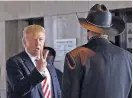  ?? THE ASSOCIATED PRESS FILE PHOTO ?? Then-Republican presidenti­al candidate Donald Trump talks with Milwaukee County Sheriff David Clarke, left, on Aug. 16, 2016, during a campaign stop at Milwaukee County War Memorial Center in Milwaukee.