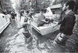  ?? Brett Coomer / Staff file photo ?? Patton Village victims are rescued during flooding spawned by Tropical Storm Imelda in 2019. New readings show the Houston area is warmer and wetter.