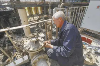  ?? AP photo ?? A worker repairs damaged thermal power plant, one of the country’s largest, recently destroyed by Russian missiles near Kharkiv, Ukraine on Friday.