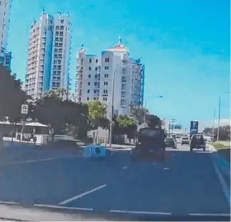  ??  ?? A washing machine falls onto the Gold Coast Highway after tumbling from a trailer.