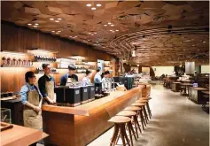  ?? (Aly Song/Reuters) ?? EMPLOYEES POSE in the new Starbucks Reserve Roastery in Shanghai yesterday.