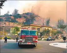  ?? Allen J. Schaben Los Angeles Times ?? SMOKE from the Silverado f ire invades Irvine’s Orchard Hills neighborho­od as f iref ighters work to protect homes Monday.