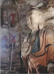  ?? PHOTOS PROVIDED TO CHINA DAILY ?? Two statues in Grotto 5 of the Yungang Grottoes in Datong, Shanxi province.