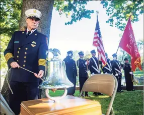  ?? Jason Edwards / For Hearst Connecticu­t Media ?? Milford Fire Department Chief Douglas Edo rings a bell for the three Milford residents killed in the September 11 attacks on the World Trade Center during the Milford 9/11 ceremony at Milford City Hall on Saturday.
