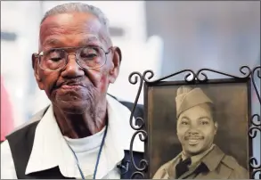  ?? Gerald Herbert / Associated Press ?? World War II veteran Lawrence Brooks holds a photo of him taken in 1943, as he celebrates his 110th birthday at the National World War II Museum in New Orleans on Sept. 12, 2019. Brooks, the oldest World War II veteran in the U.S. — and believed to be the oldest man in the country — died on Wednesday at the age of 112.