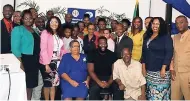  ?? FILE ?? Permanent Secretary Carol Palmer (seated left) and British Criminolog­ist Craig Pinkney (second left) with the rest of the Tivoli Gardens Restorativ­e Justice team recently.