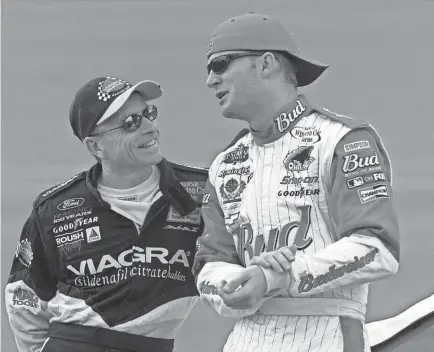 ?? KELLY JORDAN/DAYTONA BEACH NEWS-JOURNAL ?? Mark Martin, left, talks with Dale Earnhardt Jr. in 2001 at Daytona Internatio­nal Speedway. Martin will be a major presence at Darlington Raceway, just like he usually was during his stellar NASCAR career.