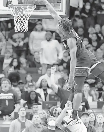  ?? CRAIG LASSIG/AP ?? Minnesota’s Anthony Edwards, right, is called for an offensive foul as he dunks over Miami’s Gabe Vincent Wednesday in Minneapoli­s.