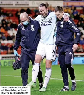  ?? ?? Sean Morrison is helped off the pitch after being injured against Barnsley