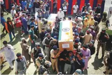  ?? AP ?? Police officers carry the bodies of the policemen abducted and killed by militants, in Shopian, south of Srinagar in Kashmir yesterday.