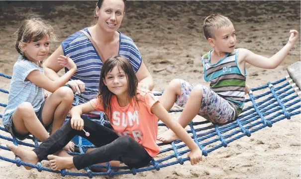  ?? Picture: ANNA ROGERS ?? PLAYING IT SAFE: Eli Axman, who is in favour of vaccinatio­ns, and her children Charlotte, 7, Olivia, 8, and Dion, 6, at Muddies playground.
