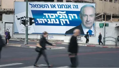  ?? MENAHEM KAHANA/AFP/GETTY IMAGES ?? A campaign poster for Israeli Prime Minister Benjamin Netanyahu and his Likud party reads, ‘It’s us or the left. Only Likud. Only Netanyahu.’ Some Israeli voters believe Netanyahu is the only grown-up in the room; others see him as the devil incarnate.