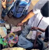  ??  ?? Local residents of Kurumalai near Anaicut checking the cash and jewels returned by policemen on Wednesday