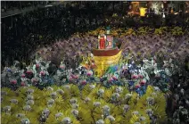  ?? SILVIA IZQUIERDO — THE ASSOCIATED PRESS ?? Performers from the Sao Clemente samba school parade are on a float Saturday during Carnival celebratio­ns in Rio de Janeiro.