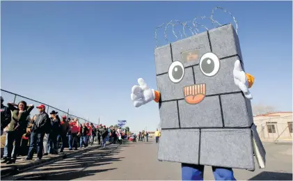  ?? Picture: Reuters ?? PRO-WALL. A Trump supporter dressed up as a border wall is seen as others queue to enter El Paso County Coliseum for a rally by US President Donald Trump in El Paso, Texas, on Monday.