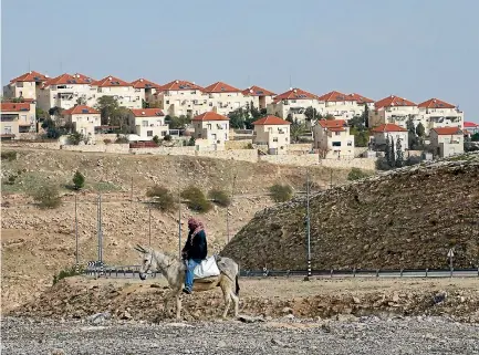  ?? PHOTO: REUTERS ?? A Palestinia­n man rides a donkey near the Israeli settlement of Maale Edumim, in the occupied West Bank.