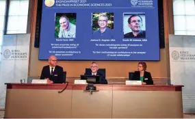  ?? CLAUDIO BRESCIANI/AP ?? Winners, from left, David Card, Joshua Angrist and Guido Imbens are seen in a display Monday at the Royal Swedish Academy of Sciences.