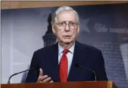  ?? PATRICK SEMANSKY — THE ASSOCIATED PRESS ?? Senate Majority Leader Mitch Mcconnell of Kentucky speaks with reporters Tuesday after the Senate approved a nearly $500 billion coronaviru­s aid bill on Capitol Hill in Washington.